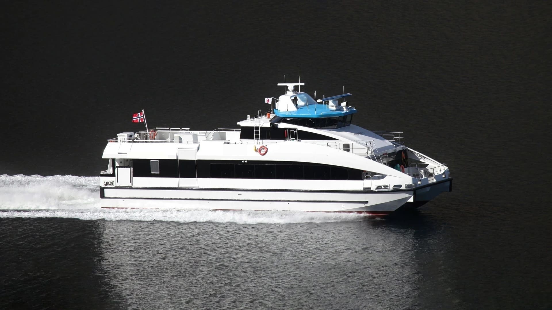 OBLUE FERRY 26 fast passenger catamaran underway on dark fjord water