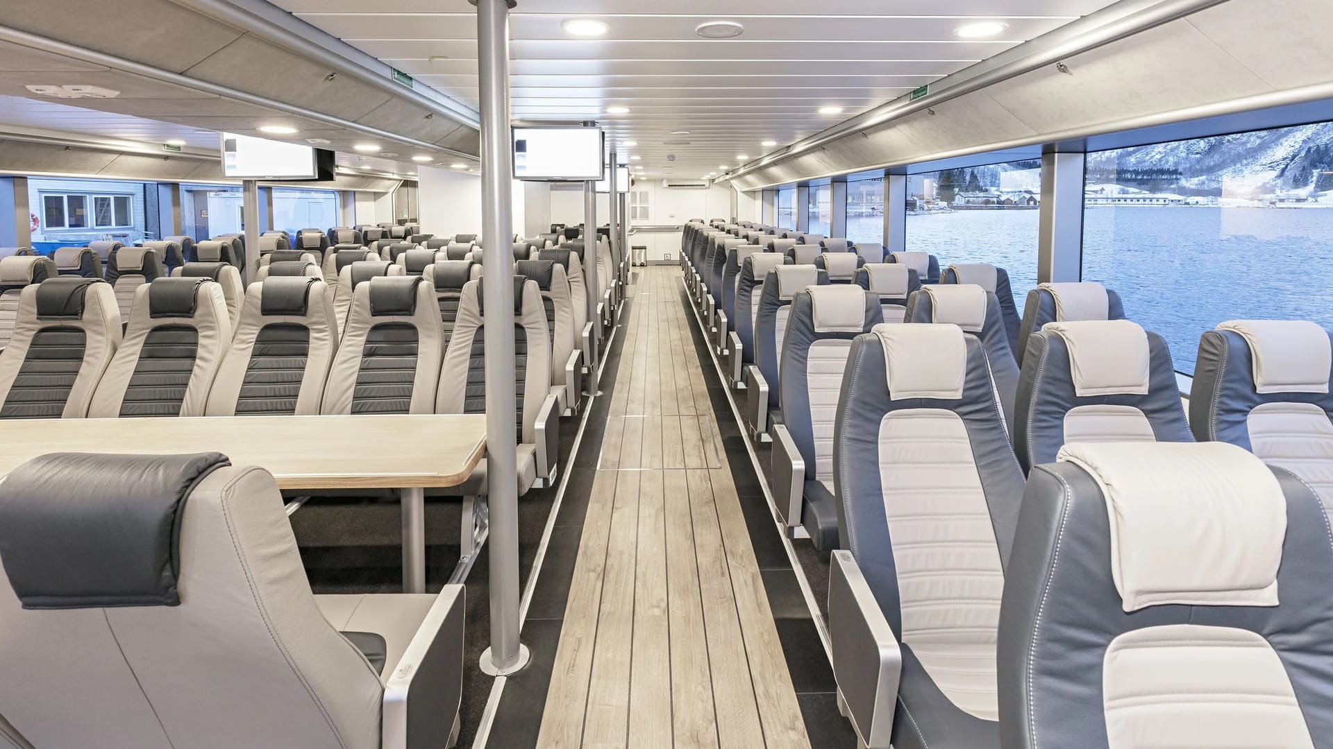 Main saloon of the OBLUE FERRY 26 with rows of seats and wide centre aisle