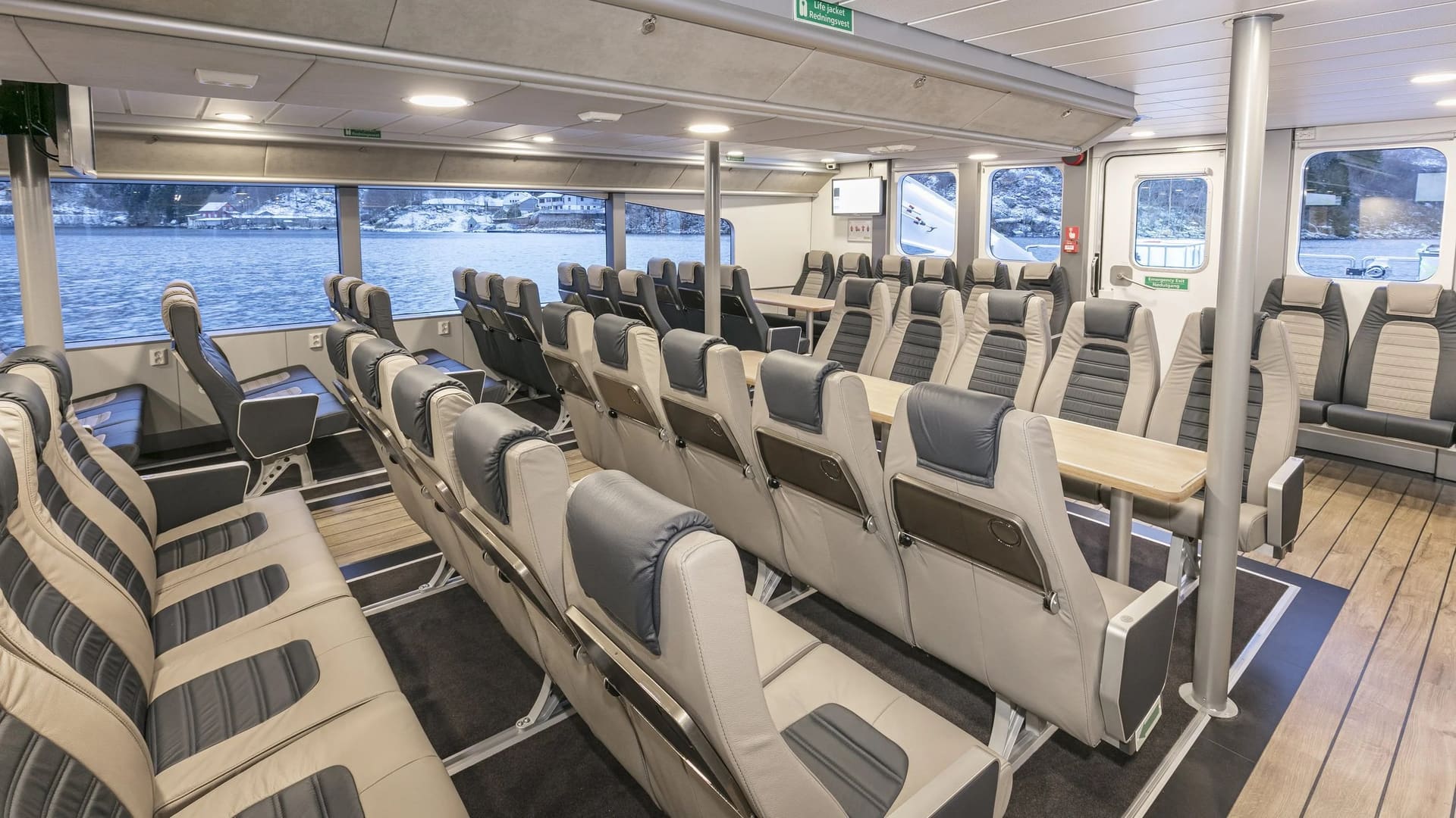 Forward seating rows with tables aboard the OBLUE FERRY 26