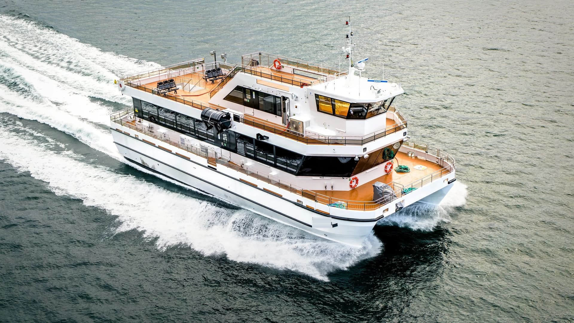 Aerial front-quarter view of the OBLUE FERRY 26H showing the open sundeck