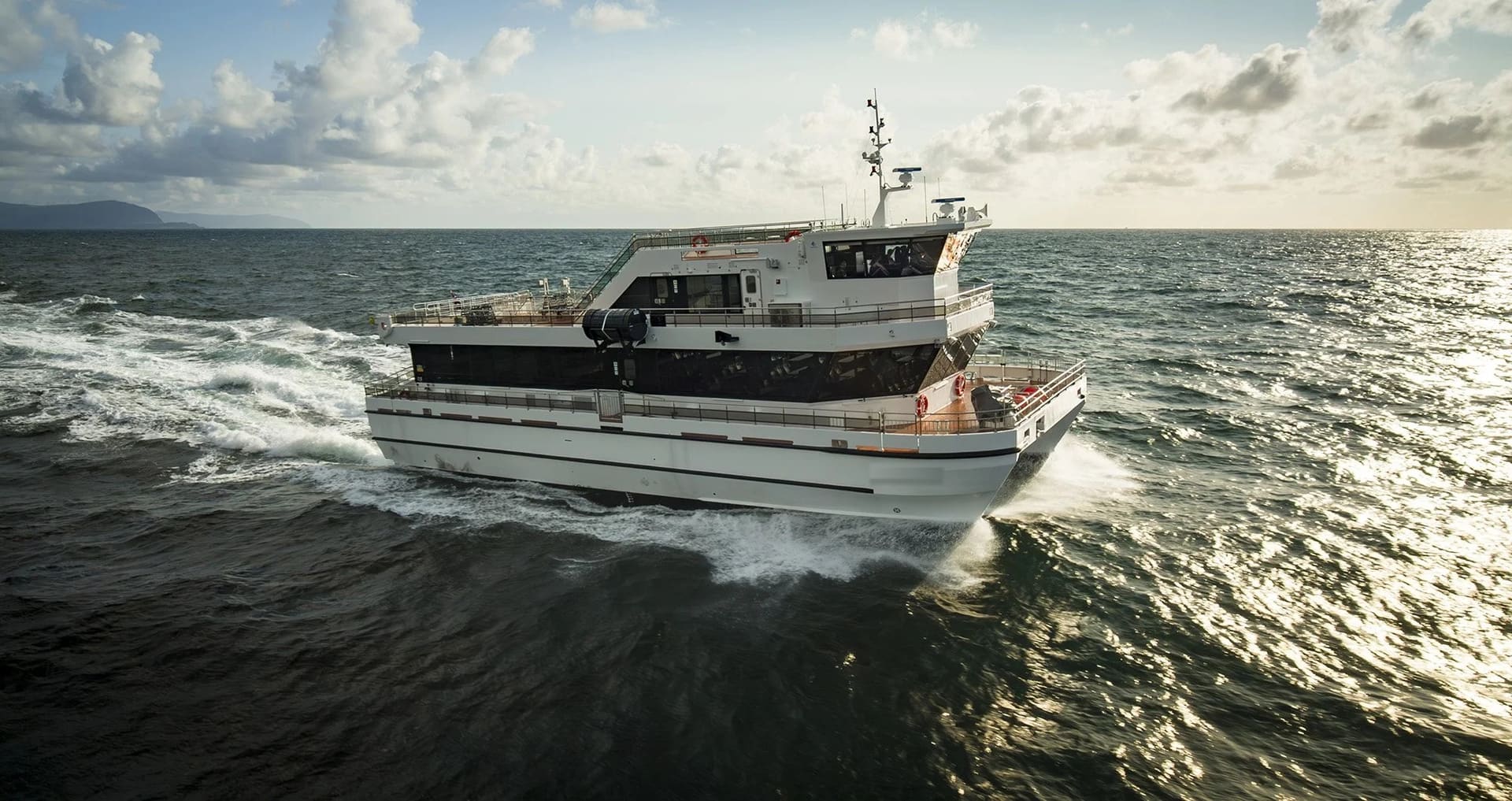 OBLUE FERRY 26H hybrid-electric catamaran underway at golden hour, side profile