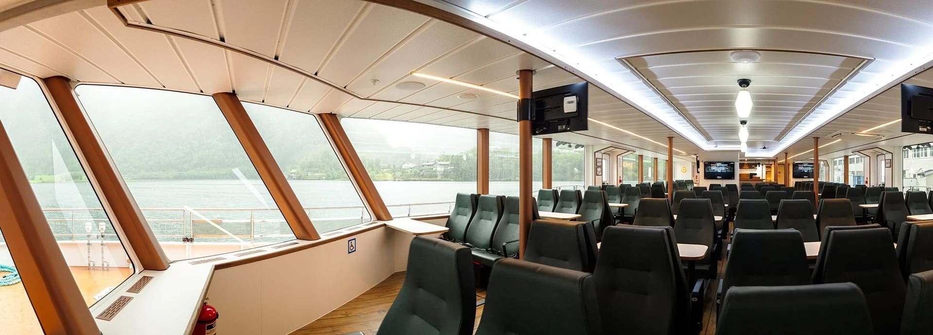 Main saloon of the OBLUE FERRY 26H with panoramic windows and rows of seats