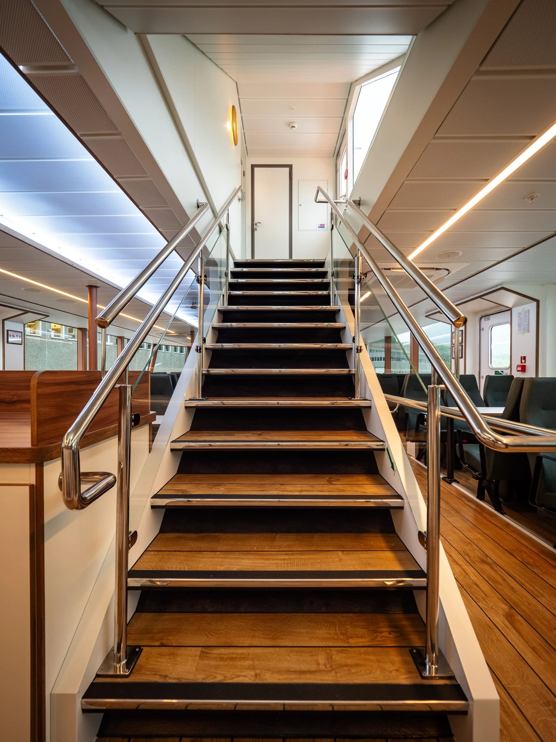 Staircase between decks with timber steps and glass balustrade