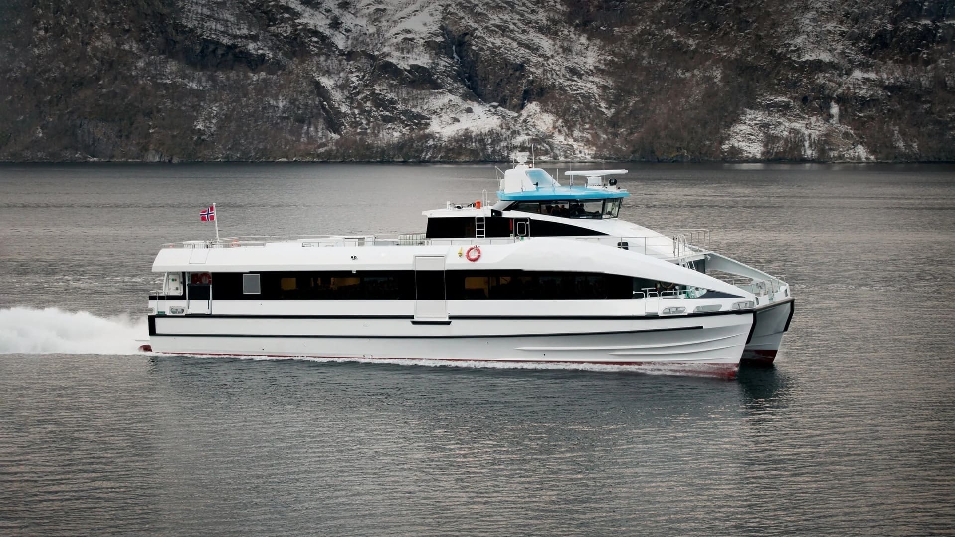 OBLUE FERRY 32 fast passenger catamaran underway, Norwegian fjord backdrop