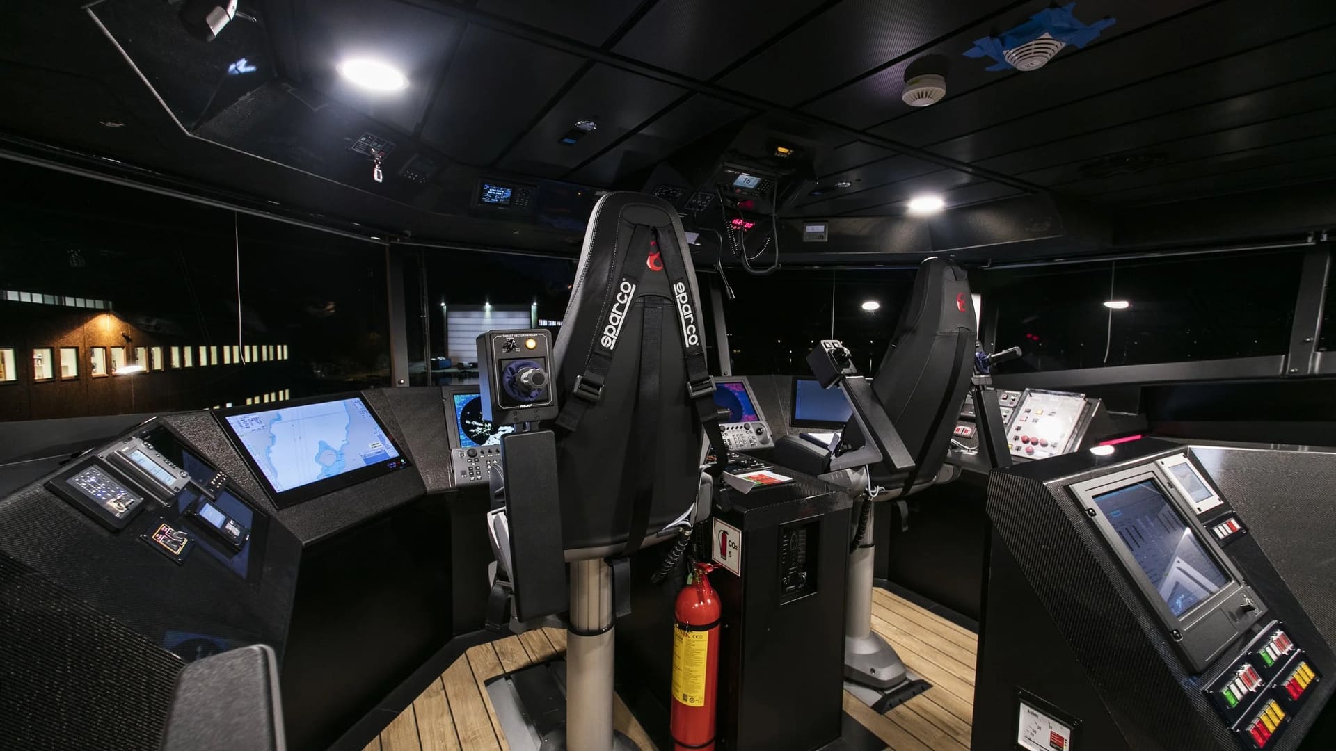 Wheelhouse of the OBLUE FERRY 32 with twin helm seats and multi-screen consoles