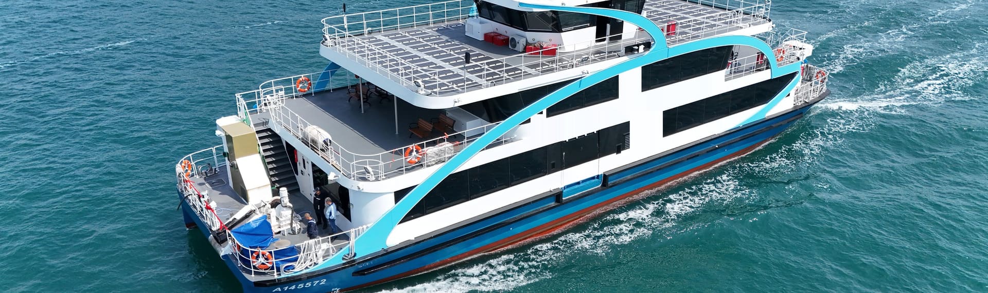 OBLUE FERRY 35E underway, leaving a wake across the harbour