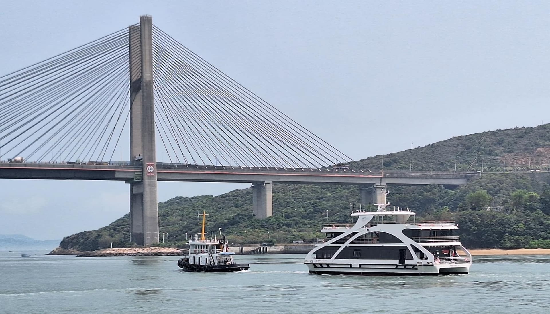 OBLUE SEASIGHT 35 on its delivery voyage under the Ting Kau Bridge