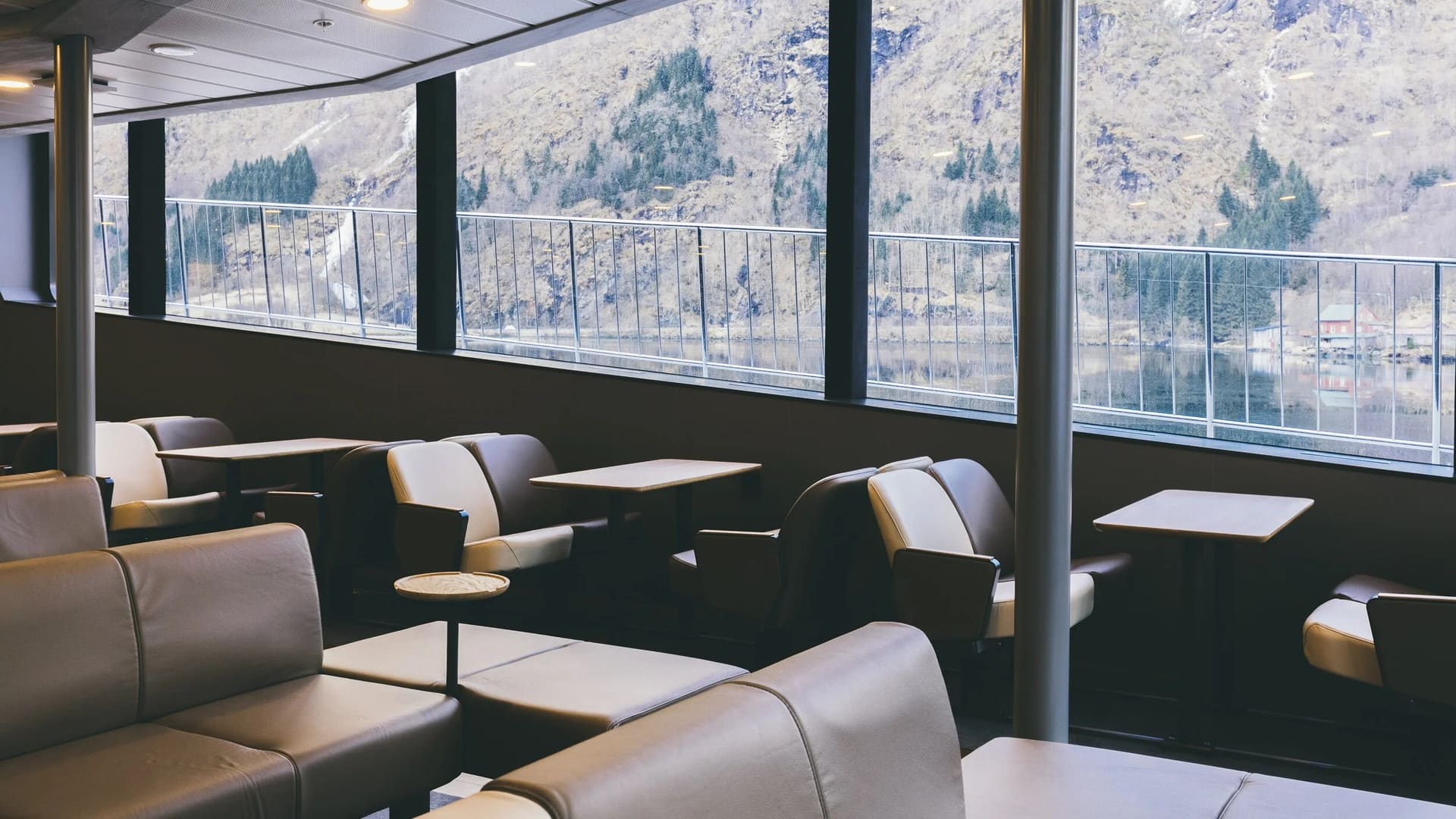 Passengers watching the fjord from the panoramic saloon